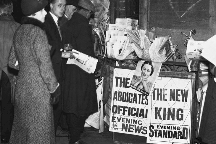 Image Credits: Getty Images / Hulton-Deutsch Collection / CORBIS | People surround a newspaper stand in Parliament Square, London, to read the news of King Edward VIII's abdication.