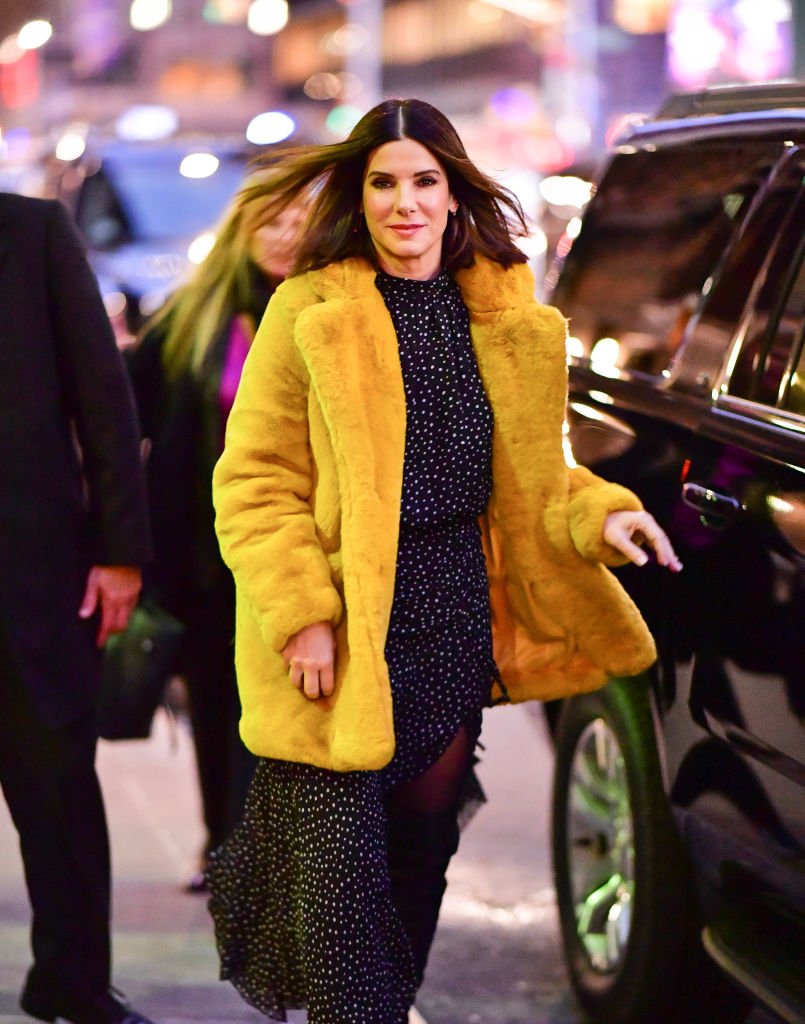Image Credits: Getty Images / James Devaney / GC Images | Sandra Bullock arrives to 'The Late Show With Stephen Colbert' at the Ed Sullivan Theater on December 17, 2018 in New York City.