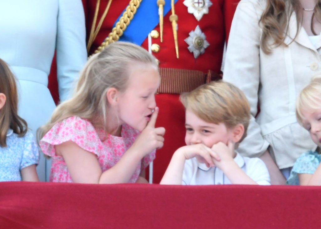 Image Credit: Getty Images / Savannah Phillips and Prince George stand on the balcony of Buckingham Palace during Trooping The Colour 2018 on June 9, 2018 in London, England. Image Credit: Getty Images / Savannah Phillips and Prince George stand on the balcony of Buckingham Palace during Trooping The Colour 2018 on June 9, 2018 in London, England.