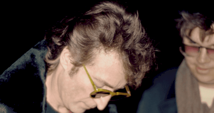 Image Credit: Getty Images / Beatles musician John Lennon signs a copy of his "Double Fantasy" album for Mark David Chapman.