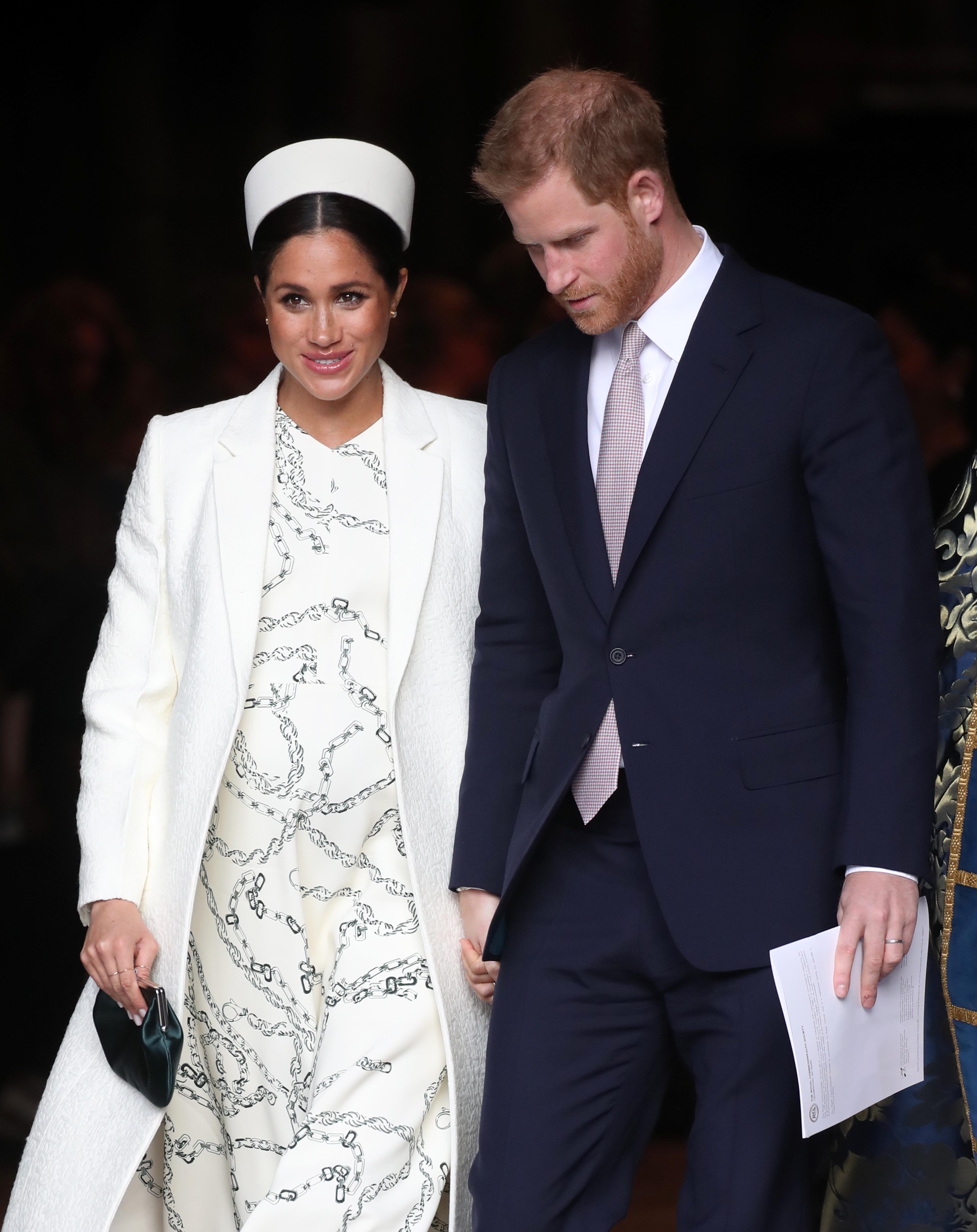 Image Credits: Getty Images | Prince Harry and Meghan Markle are photographed on a royal trip.