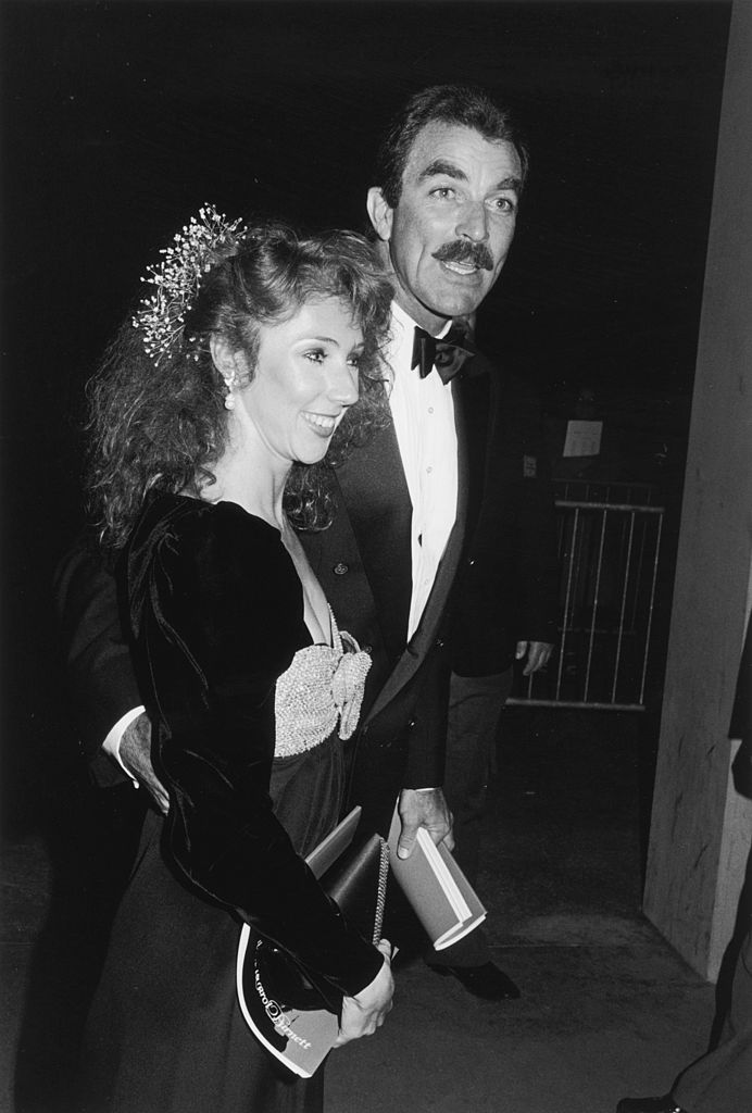 Image Source: Getty Images / Darlene Hammond | American actor Tom Selleck and his girlfriend, Jillie Mack, attend a Tribute to Carol Burnett on the UCLA campus, Los Angeles, California.