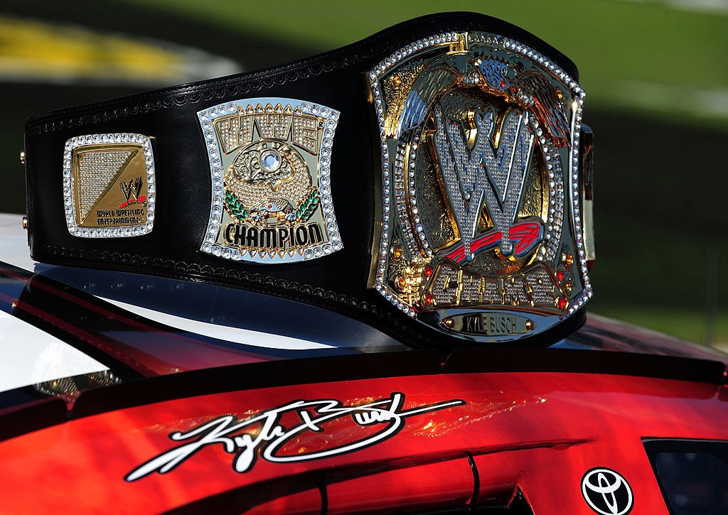 Image Credits: Getty Images / Robert Laberge | A replica of the WWE world championship belt rests on top of Kyle Busch's #18 Z-Line Designs/WWE Smackdown Toyota prior to the start of the NASCAR Nationwide Series O'Reilly Challenge at Texas Motor Speedway on November 7, 2009 in Fort Worth, Texas.
