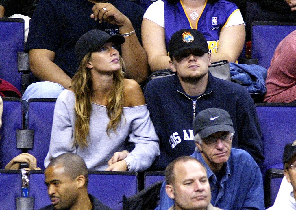Image Source: Getty Images/Vince Bucci|Actor Leonardo Di Caprio (C) and model Gisele Bundchen (L) attend the game between the Los Angeles Lakers and the Utah Jazz on December 7, 2003 in Los Angeles, California