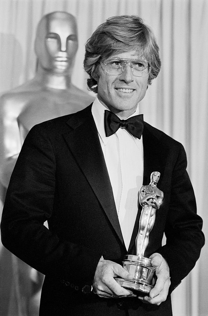 Image Credits: Getty Images / Bettmann | Robert Redford admires his Oscar after he won it for Best Achievement for Directing in the movie, Ordinary People. The Oscar was one of the two top awards won by the film, the second being the Best Picture award.