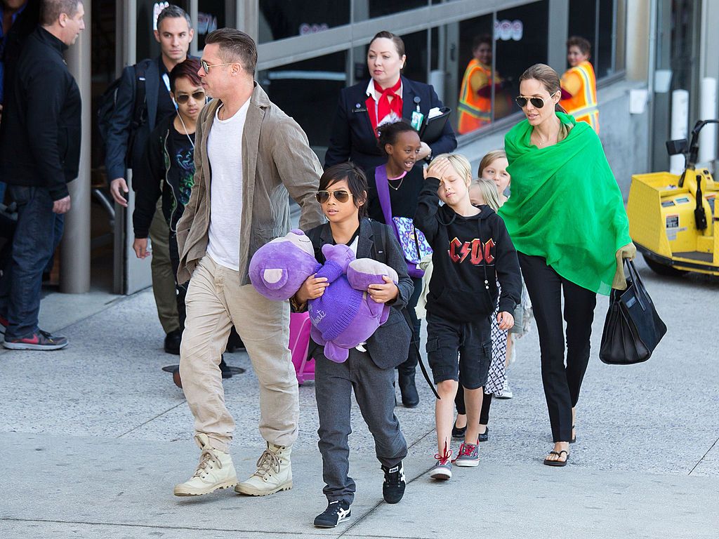 Brad Pitt and Angelina Jolie are seen after landing at Los Angeles International Airport with their children, Pax Jolie-Pitt, Maddox Jolie-Pitt, Shiloh Jolie-Pitt, Zahara Jolie-Pitt, Vivienne Jolie-Pitt and Knox Jolie-Pitt on February 05, 2014 in Los Angeles, California. (Photo by GVK/Bauer-Griffin/GC Images)