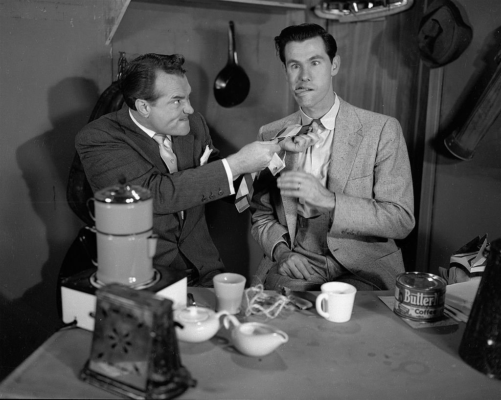 Image Credits: Getty Images / CBS Photo Archive | In a skit set in a kitchen, American comedian Red Skelton (1913 - 1997) tugs on the tie of fellow comedian Johnny Carson (1925 - 2005), a guest on 'The Red Skelton Show,' 1953. Both men make goofy faces, with Carson pretending to strangle.