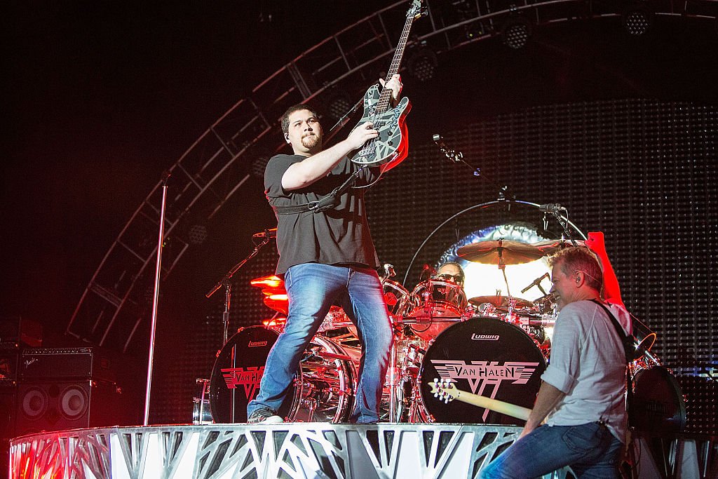 Image Credit: Getty Images / Musicians Eddie Van Halen (R) and Wolfgang Van Halen of Van Halen perform on stage at Sleep Train Amphitheatre on September 30, 2015 in Chula Vista, California.