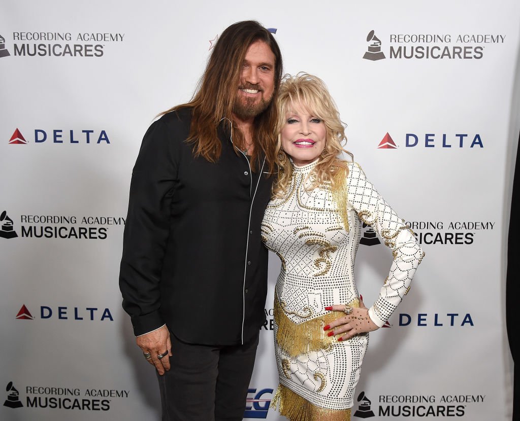 Image Credits: Getty Images / Michael Kovac | Billy Ray Cyrus and Dolly Parton attend MusiCares Person of the Year honoring Dolly Parton