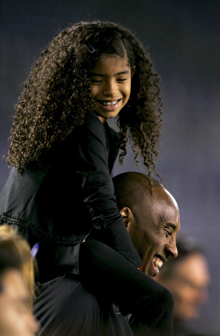 Image Credits: Getty Images / Kent C. Horner | NBA Los Angeles Laker Kobe Bryant stands on the sideline with his daughter Gianna Maria-Onore Bryant on his shoulders prior to the start of the game against the United States and China during an international firendly match at Qualcomm Stadium on April 10, 2014 in San Diego, California. Image Credits: Getty Images / Kent C. Horner | NBA Los Angeles Laker Kobe Bryant stands on the sideline with his daughter Gianna Maria-Onore Bryant on his shoulders prior to the start of the game against the United States and China during an international firendly match at Qualcomm Stadium on April 10, 2014 in San Diego, California.