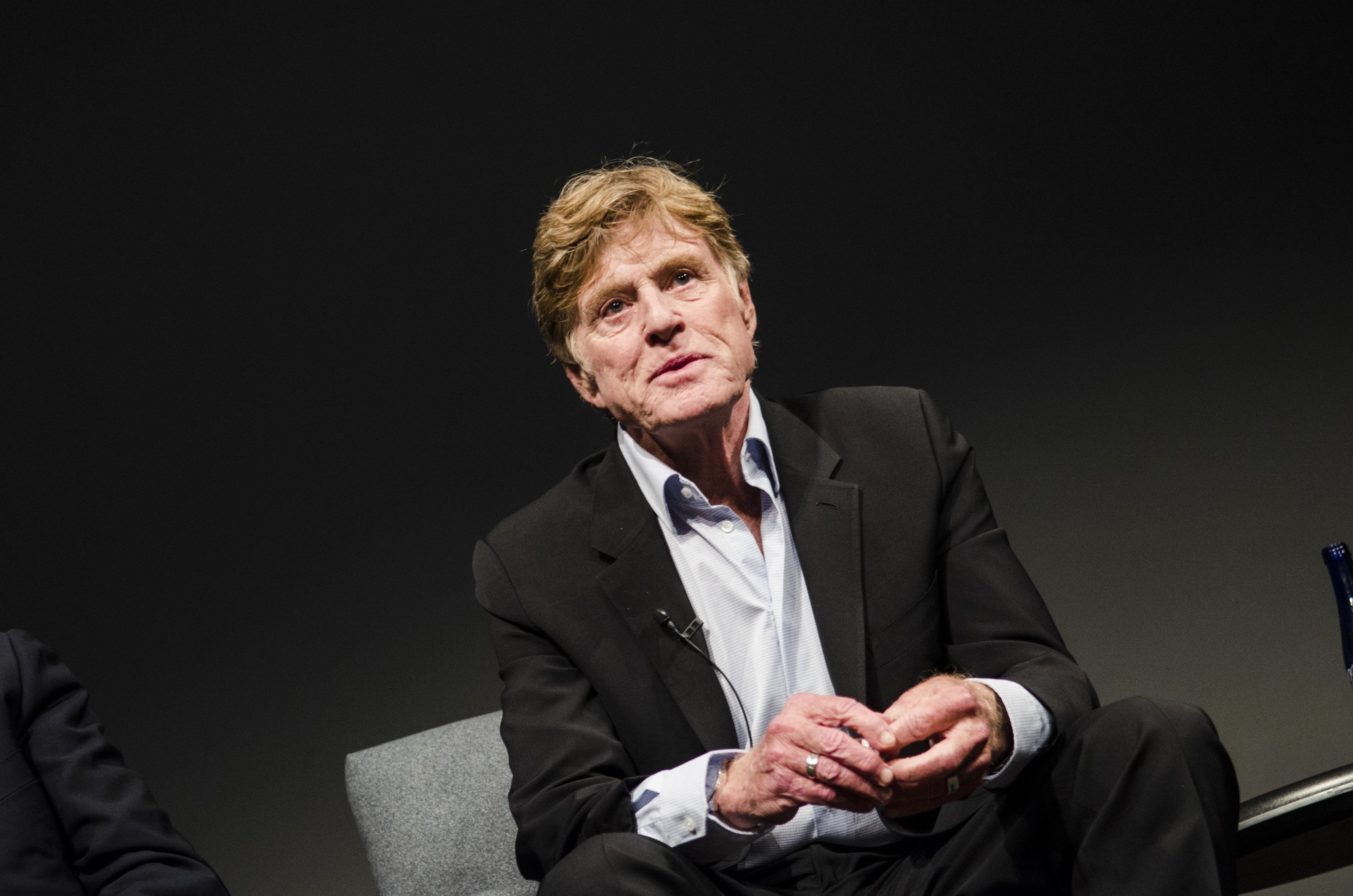 Image Credits: Getty Images / Kris Connor | Robert Redford speaks during the "All The Presidents Men Revisited" screening at The Newseum on April 18, 2013 in Washington, DC.