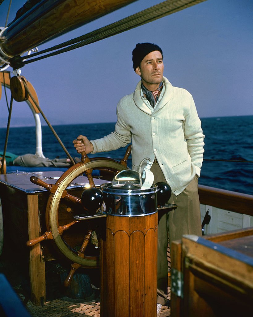 Image Source: Getty Images/Silver Screen Collection/Errol Flynn (1909-1959), Australian actor, at the wheel of his schooner, 'The Zaca', in a publicity still issued for the film, 'Cruise of the Zaca', 1952