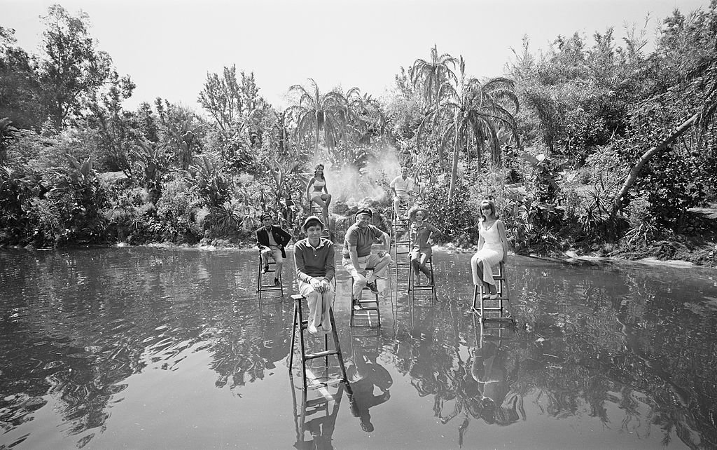 Image Credit: Getty Images / LOS ANGELES - APRIL 15: GILLIGAN'S ISLAND. Cast posed on ladders in the lagoon. (from left) Jim Backus (as Thurston Howell III); in foreground: Bob Denver (as Gilligan); Dawn Wells (as Mary Ann Summers); Alan Hale, Jr. (as The Skipper, Jonas Grumby); Russell Johnson (as The Professor, Roy Hinkley); Natalie Schafer (as Mrs. Lovey Howell) and Tina Louise (as Ginger Grant). Image dated April 15, 1966.