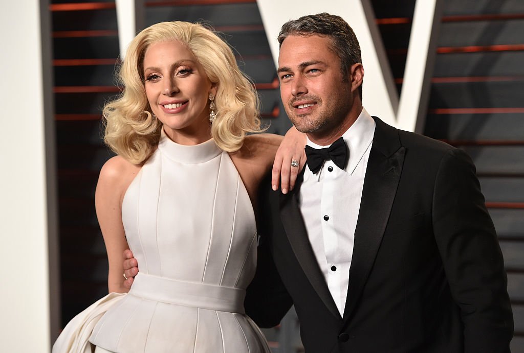 Image Source: Getty Images/John Shearer/Recording artist Lady Gaga (L) and Taylor Kinney arrive at the 2016 Vanity Fair Oscar Party Hosted By Graydon Carter at Wallis Annenberg Center for the Performing Arts on February 28, 2016