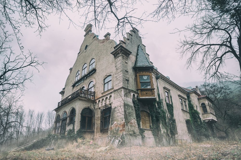 Old abandoned mansion in mystic spooky forest | Shutterstock