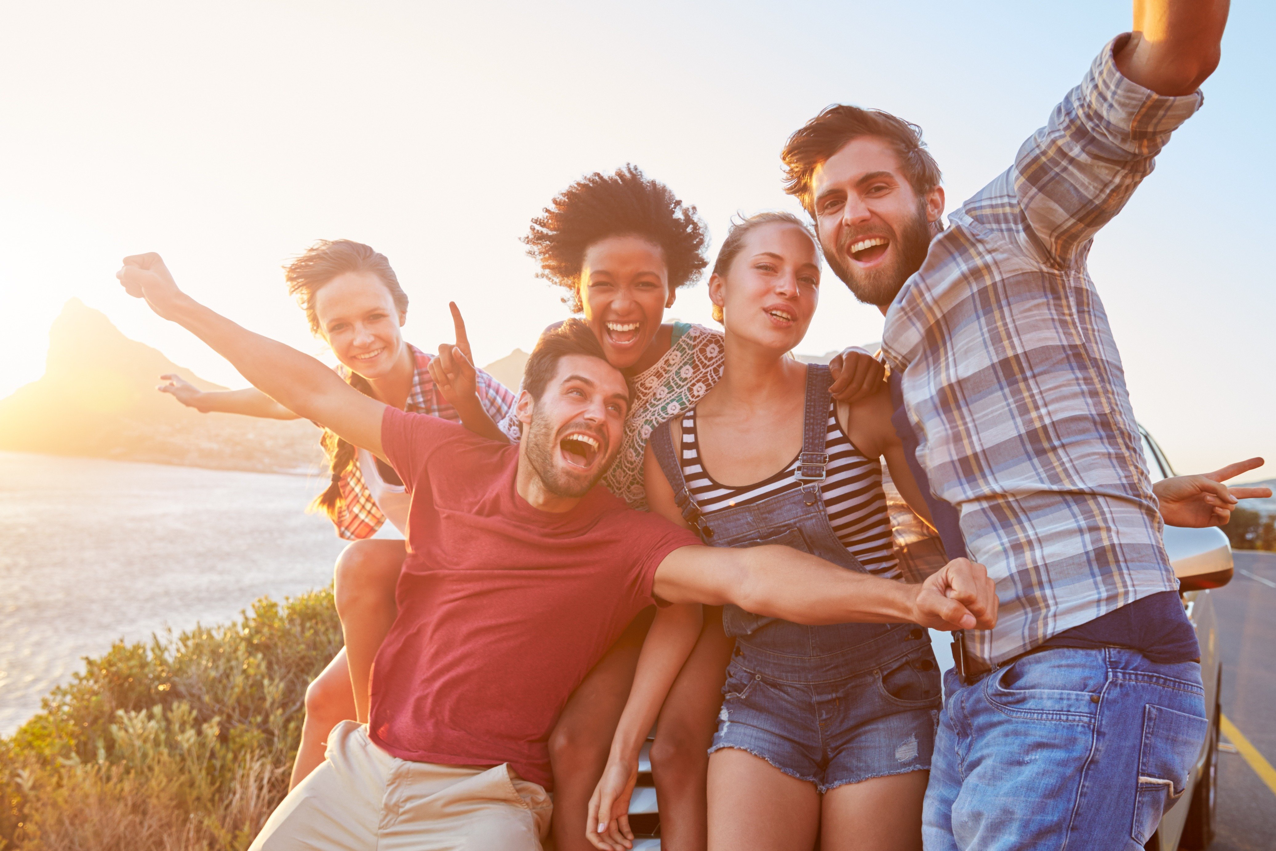 Image Credits: Shutterstock / Friends enjoying sunset