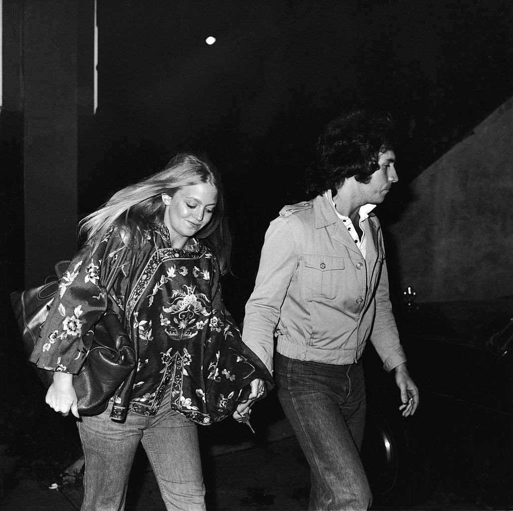 Image Credits: Getty Images / Frank Edwards / Fotos International | American actress Goldie Hawn and her second husband musician and television variety show host Bill Hudson arrive at the premiere of 'Taxi Driver,' February 8, 1976.