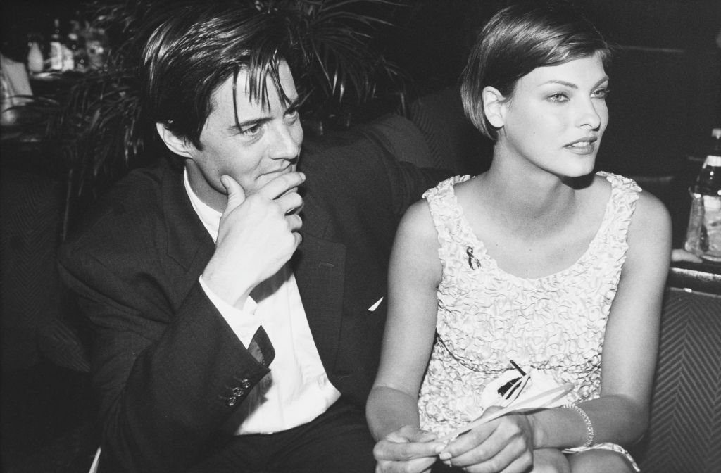 Image Source: Getty Images/Richard Blanshard | American actor Kyle MacLachlan and his girlfriend, Canadian model Linda Evangelista attend a party for the film 'Ed Wood' at the Cannes Film Festival, France, May 1995