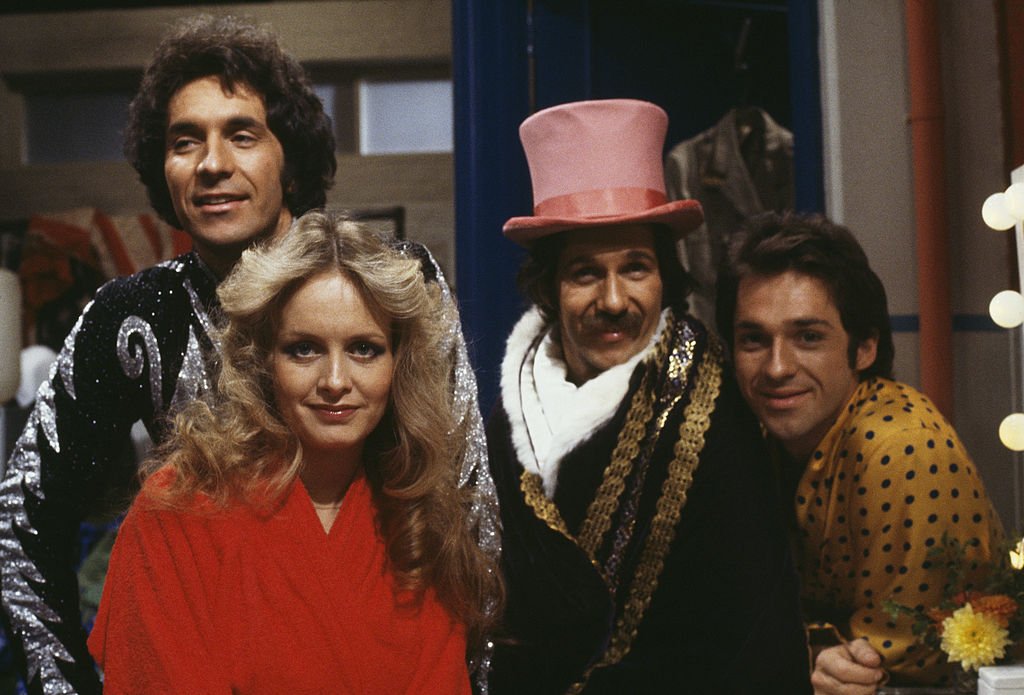 Image Credits: Getty Images / Richard Blanshard | The Hudson Brothers, Bill Hudson, Brett Hudson and Mark Hudson, with model and actress Twiggy in the television comedy show 'Bonkers!', 1979.
