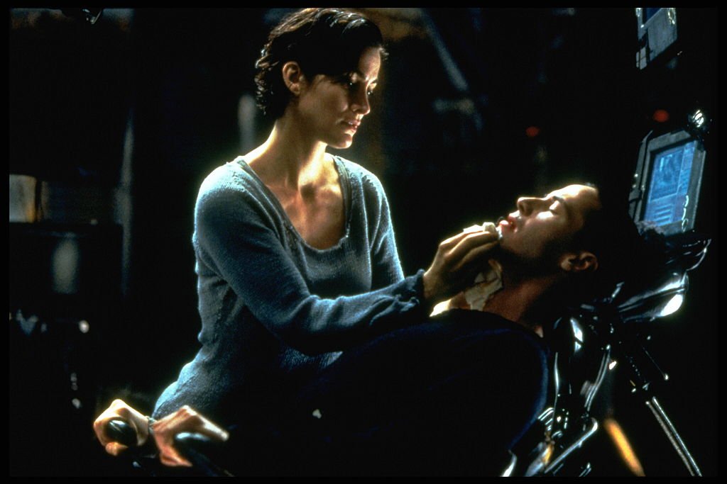 Image Credits: Getty Images / Ronald Siemoneit / Sygma | Carrie-Anne Moss and Keanu Reeves in The Matrix.
