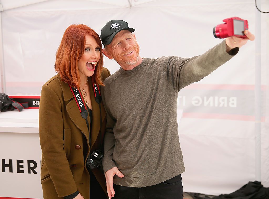 Actress Bryce Dallas Howard, with filmmaker Ron Howard, hosts the Canon Let It Snow Globe spectacle / Getty Images