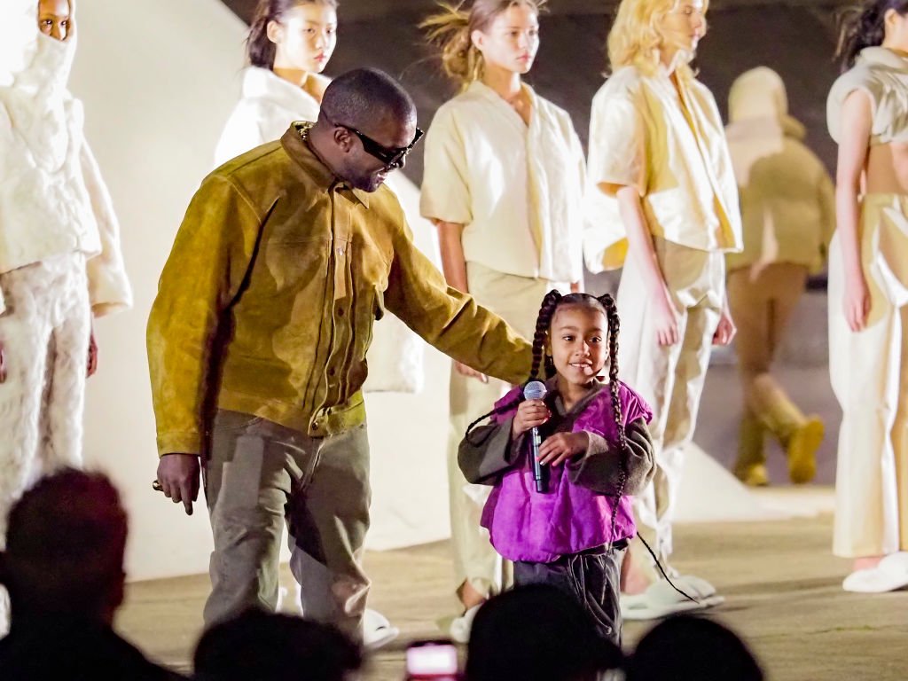 Image Credit: Getty Images / Kanye West and daughter North West attends the "Yeezy Season 8" show as part of the Paris Fashion Week Womenswear Fall/Winter 2020/2021 on March 02, 2020 in Paris, France.