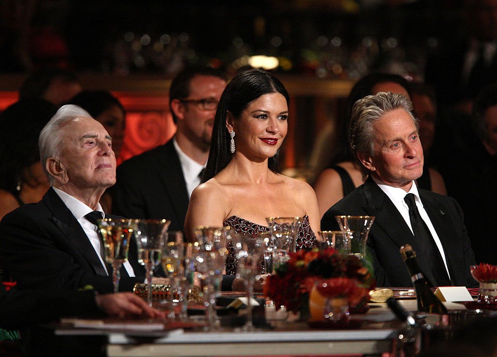Image Credits: Getty Images / Frazer Harrison | Actors Kirk Douglas, Catherine Zeta-Jones and Michael Douglas in the audience during the AFI Lifetime Achievement Award: A Tribute to Michael Douglas held at Sony Pictures Studios on June 11, 2009 in Culver City, California.