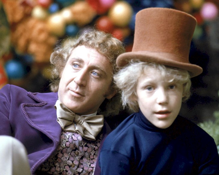 Image Credit: Getty Images/Silver Screen Collection | Gene Wilder as Willy Wonka and Peter Ostrum as Charlie Bucket on the set of the fantasy film 'Willy Wonka & the Chocolate Factory'