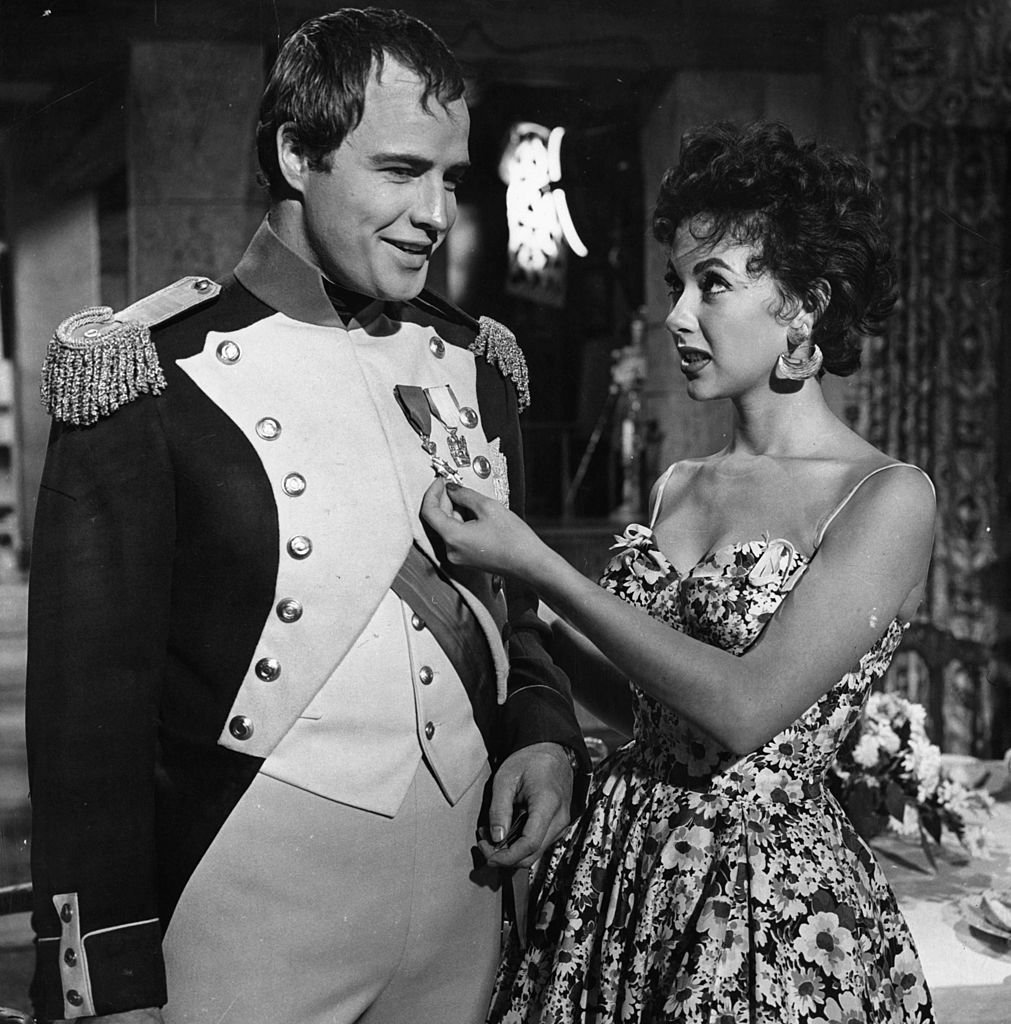 Image Credits: Getty Images / 20th Century-Fox | Moreno and Brando on the set of "Desiree"