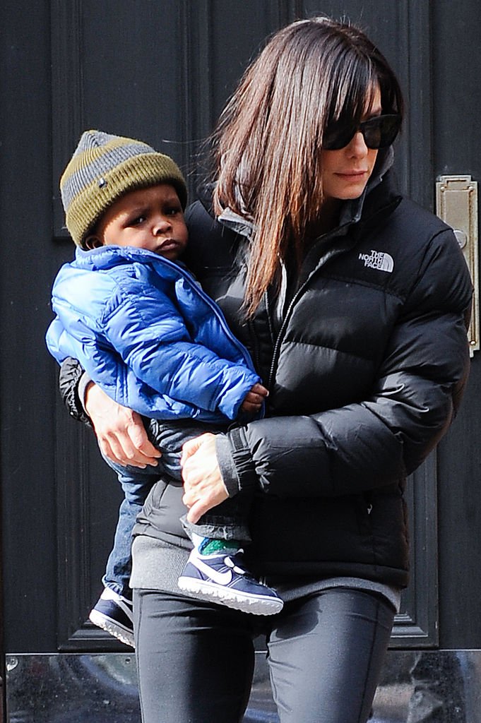 Image Credits: Getty Images / Ray Tamarra | Actress Sandra Bullock (R) and her son Louis Bullock leave their Soho home on January 20, 2011 in New York City.