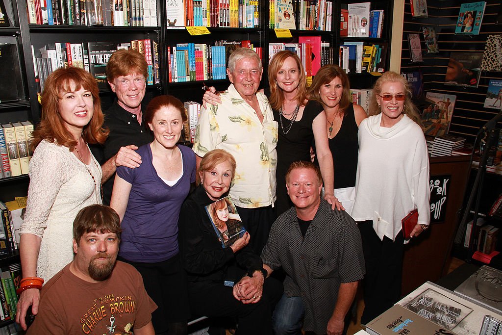 Image Credits: Getty Images / Brian Putnam | (L-R) Cast members from 'The Waltons' Lee Purcell, David W. Harper, Jon Walmsley, Kami Cotler, Michael Learned, Ralph Waite, Mary McDonough, Eric Scott, Judy Norton and Cissy Wellman attend the signing of Mary McDonough's book 'Lessons From the Mountain: What I Learned From Erin Walton' at Book Soup on April 16, 2011 in West Hollywood, California.