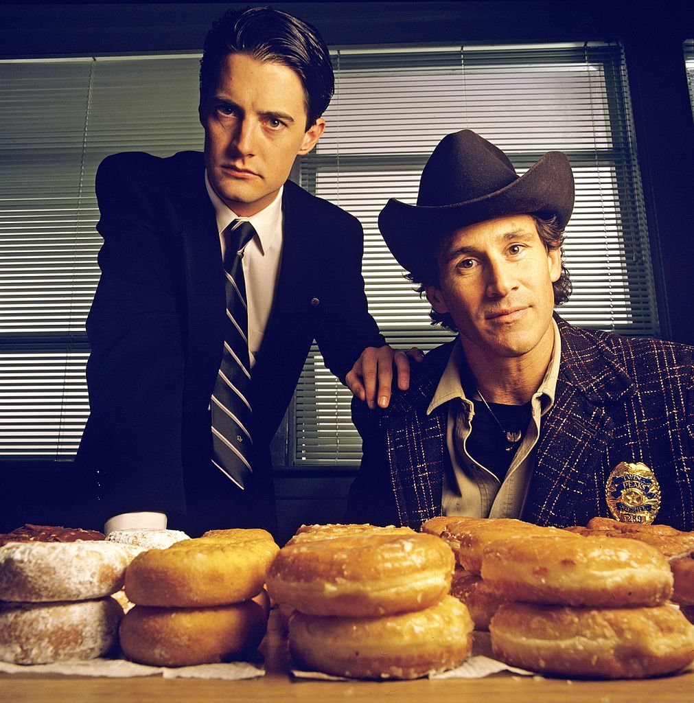 Image Credits: Getty Images / Walt Disney Television | Twin Peaks. Homecoming queen Laura Palmer is found dead, washed up on a riverbank wrapped in plastic sheeting. FBI Special Agent Dale Cooper (Kyle MacLaughlin, left) is called in to work with local Sheriff Harry S.Truman (Michael Ontkean) in the investigation of the gruesome murder in the small Northwestern town of Twin Peaks.