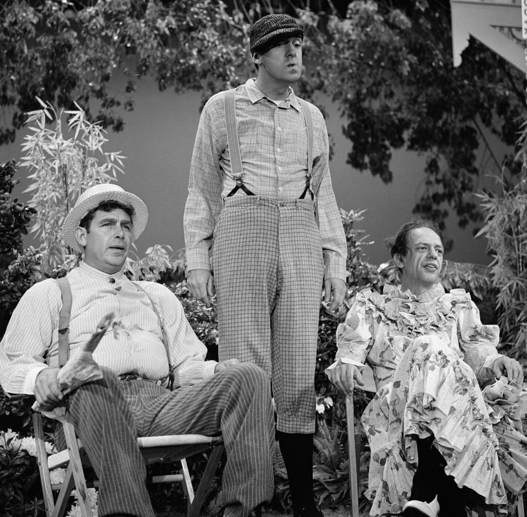 Image Source: Getty Images/CBS Photo Archive| American television actors Andy Griffith (in straw hat), Jim Nabors (dressed as a boy in a cap), and Don Knotts (in a dress) appear together in a televised skit, September 12, 1965