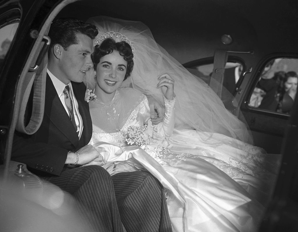 Image Credit: Getty Images / Actress Elizabeth Taylor and her groom, Conrad "Nickie" Hilton, Jr. off to their wedding reception at the Bel-Air Country Club.