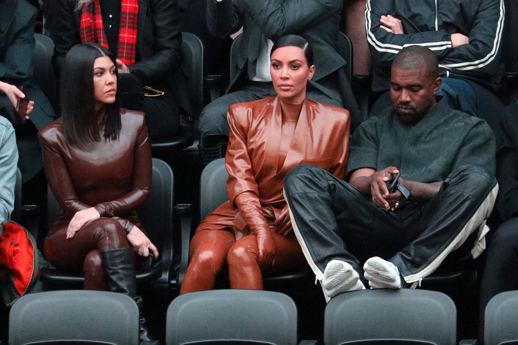 Image Credits: Getty Images / Pierre Suu | Kourtney Kardashian,Kim Kardashian and Kanye West attend the Balenciaga show
