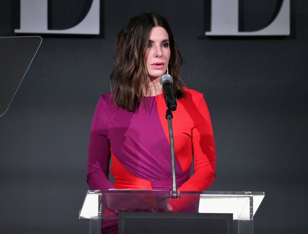 Image Credits: Getty Images / Michael Kovac | Sandra Bullock speaks onstage during ELLE's 25th Annual Women In Hollywood Celebration presented by L'Oreal Paris, Hearts On Fire and CALVIN KLEIN at Four Seasons Hotel Los Angeles at Beverly Hills on October 15, 2018 in Los Angeles, California.