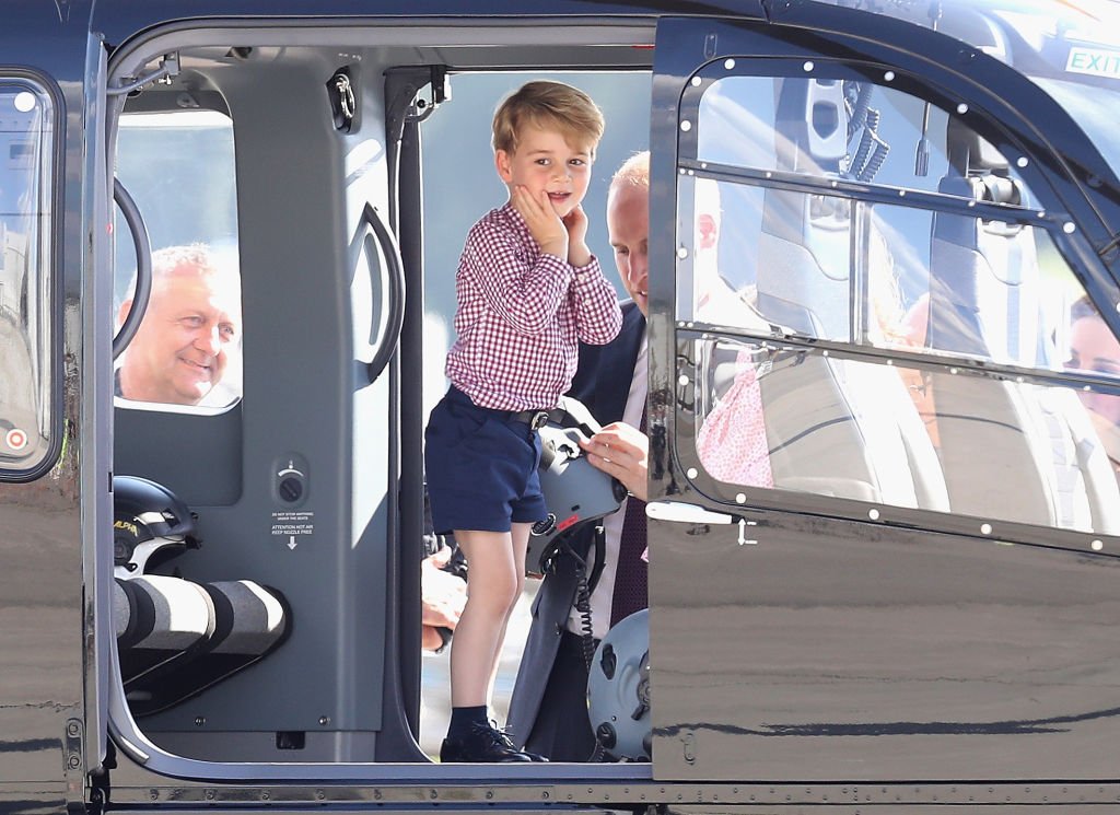Image Credit: Getty Images / Prince George of Cambridge view helicopter models before departing on the last day of their official visit to Poland and Germany on July 21, 2017.