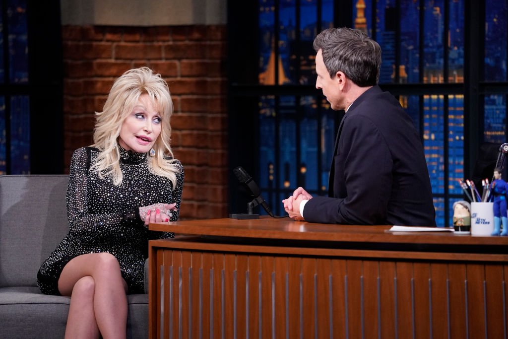 Image Credits: Getty Images / Lloyd Bishop / NBC / NBCU Photo Bank | Singer Dolly Parton during an interview with host Seth Meyers on November 21, 2019. Image Credits: Getty Images / Lloyd Bishop / NBC / NBCU Photo Bank | Singer Dolly Parton during an interview with host Seth Meyers on November 21, 2019.