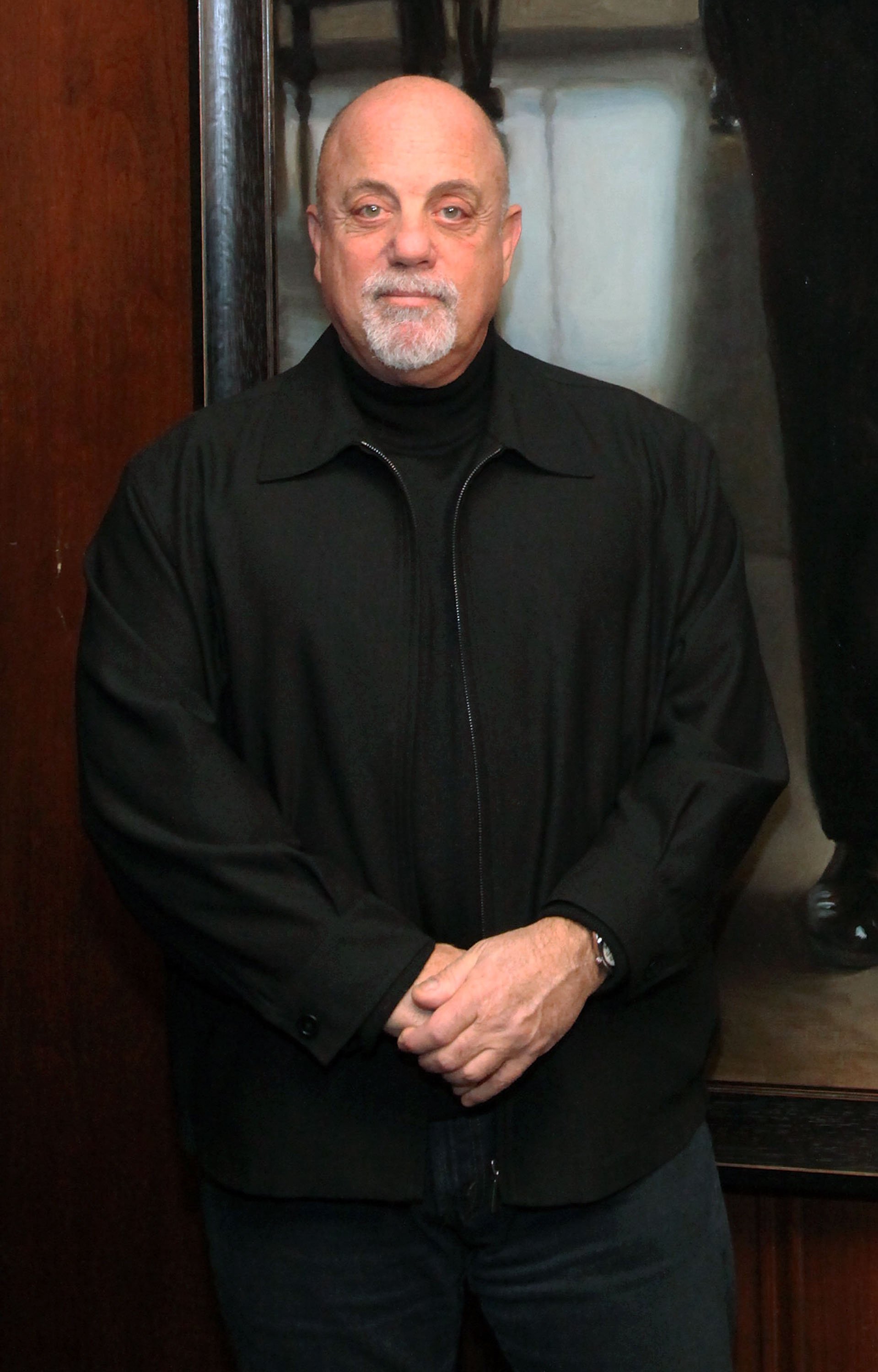Image Credits: Getty Images / Astrid Stawiarz | Billy Joel stands next to his Steinway Hall Portrait at Steinway Hall on December 12, 2011 in New York City. Image Credits: Getty Images / Astrid Stawiarz | Billy Joel stands next to his Steinway Hall Portrait at Steinway Hall on December 12, 2011 in New York City.