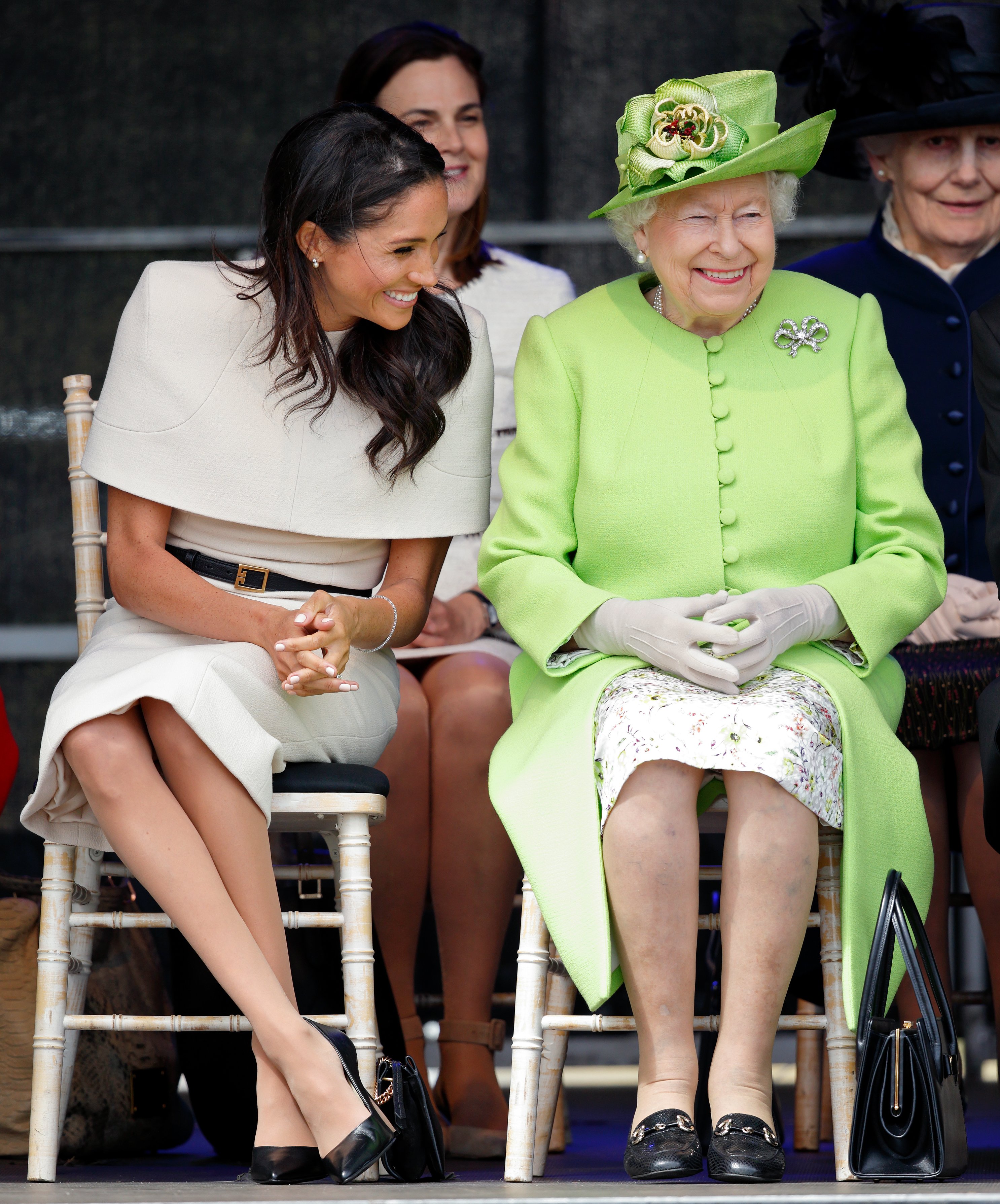 Image Credits: Getty Images / Max Mumby / Indigo | Meghan, Duchess of Sussex and Queen Elizabeth II attend a ceremony to open the new Mersey Gateway Bridge on June 14, 2018 in Widnes, England. Meghan Markle married Prince Harry last month to become The Duchess of Sussex and this is her first engagement with the Queen. During the visit the pair will open a road bridge in Widnes and visit The Storyhouse and Town Hall in Chester.