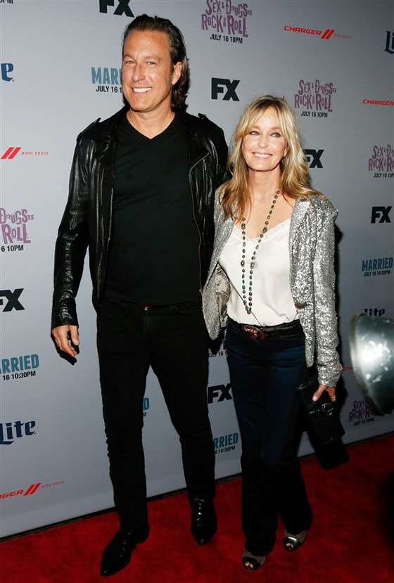 Image Credits: Getty Images / / The model and Hollywood actor Bo Derek and John Corbett are photographed by the press.