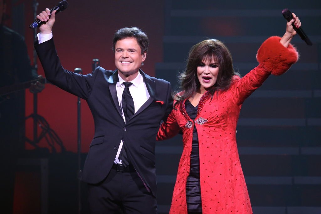 Image Credit: Getty Images / Entertainers Donny and Marie Osmond are shown performing on stage during a "live" holiday concert show on December 27, 2014.