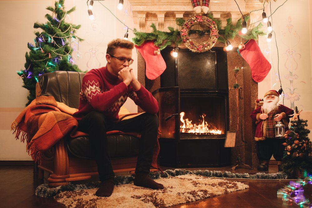Man reflects on his year at Christmas time | Unsplash Man reflects on his year at Christmas time | Unsplash
