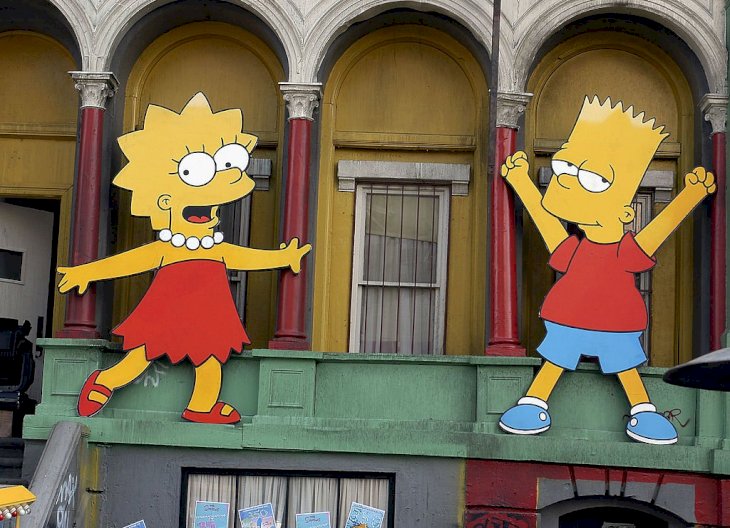 Image Credit: Getty Images/Stephen Shugerman | RIL 25: Lisa Simpson and Bart Simpson cut-outs on display at "The Simpsons" 350th episode block party