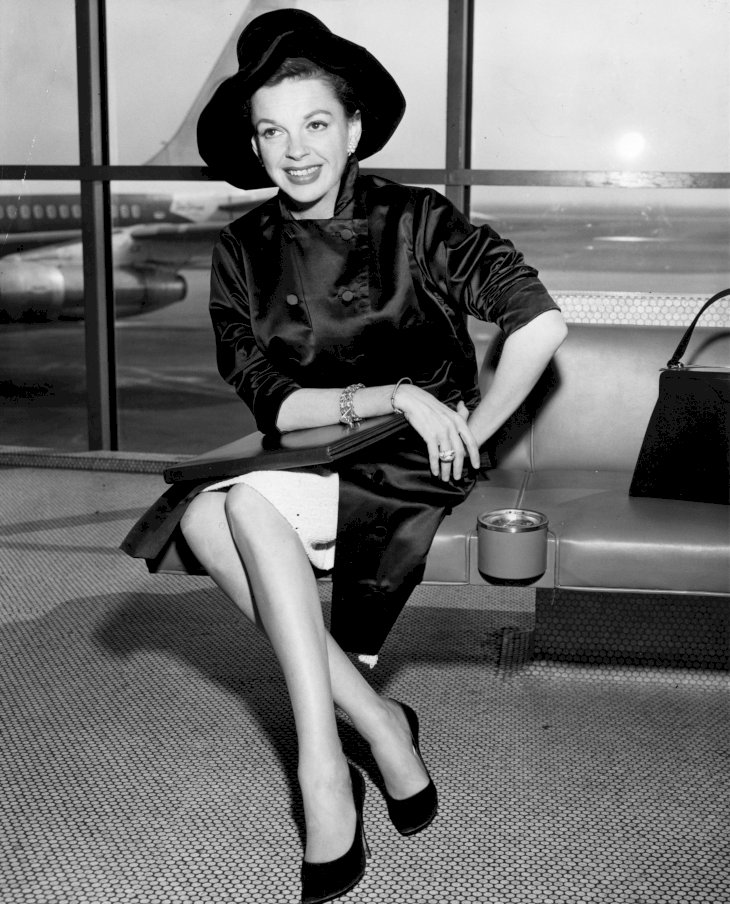 Image Credit: Getty Images/Keystone | Singer and film star, Judy Garland at an airport circa 1955.