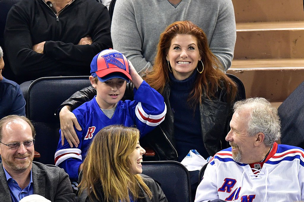 Image Source: Getty Images/James Devaney| Debra Messing and son Roman Zelman attend the Tampa Bay Lightning vs New York Rangers playoff game at Madison Square Garden on May 16, 2015 in New York City