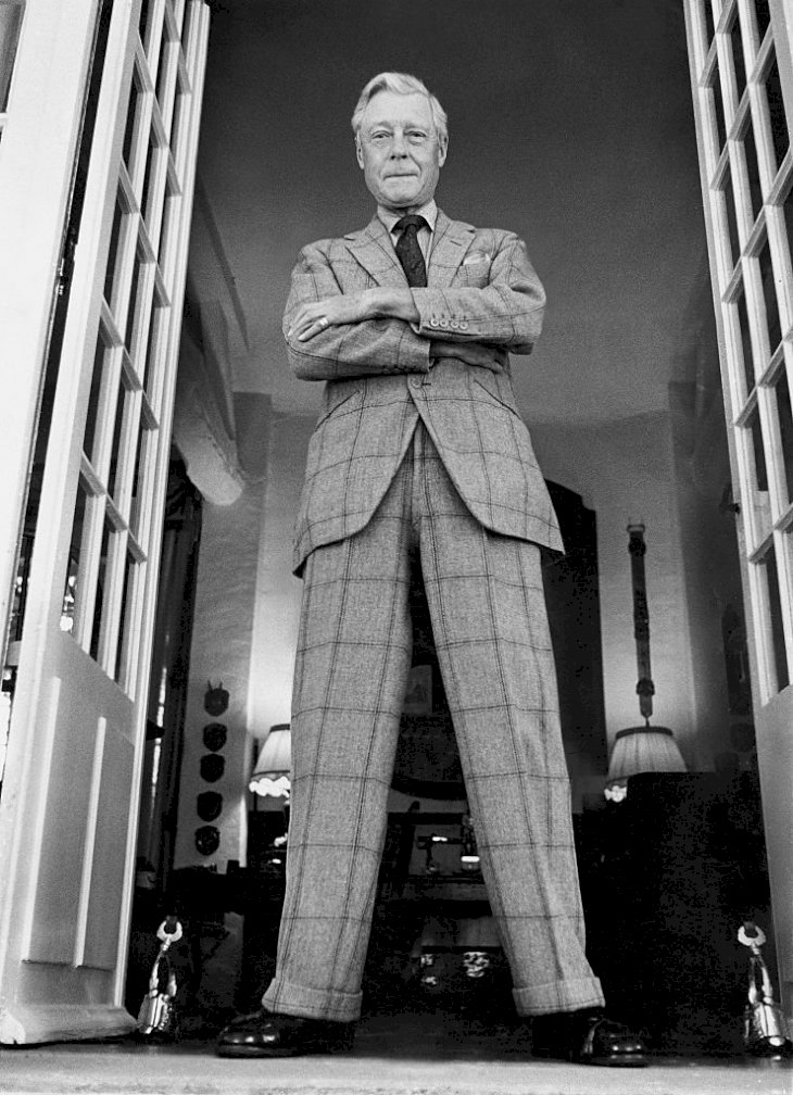 Image Credits: Getty Images / Patrick Lichfield / Condé Nast | The Duke of Windsor (aka King Edward VIII) arms crossed, standing in a doorway of Moulin de la Tuileries, his home outside Paris.