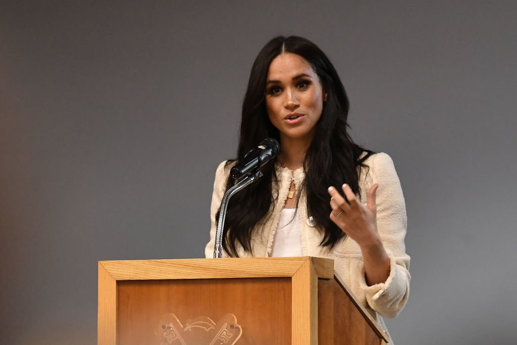 Image Credit: Getty Images / Meghan, Duchess of Sussex speaks during a special school assembly at the Robert Clack Upper School in Dagenham ahead of International Women’s Day on March 6, 2020 in London, England.