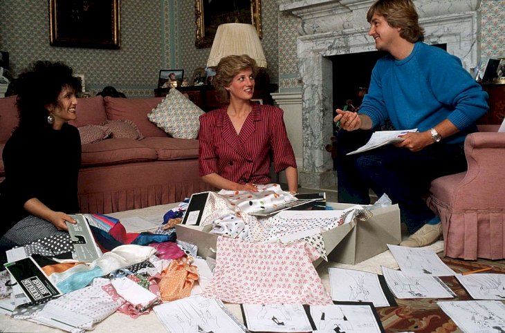 Image Credit: Getty Images/Tim Graham Photo Library via Getty Images | Princess Diana with her designers, The Emmanuels
