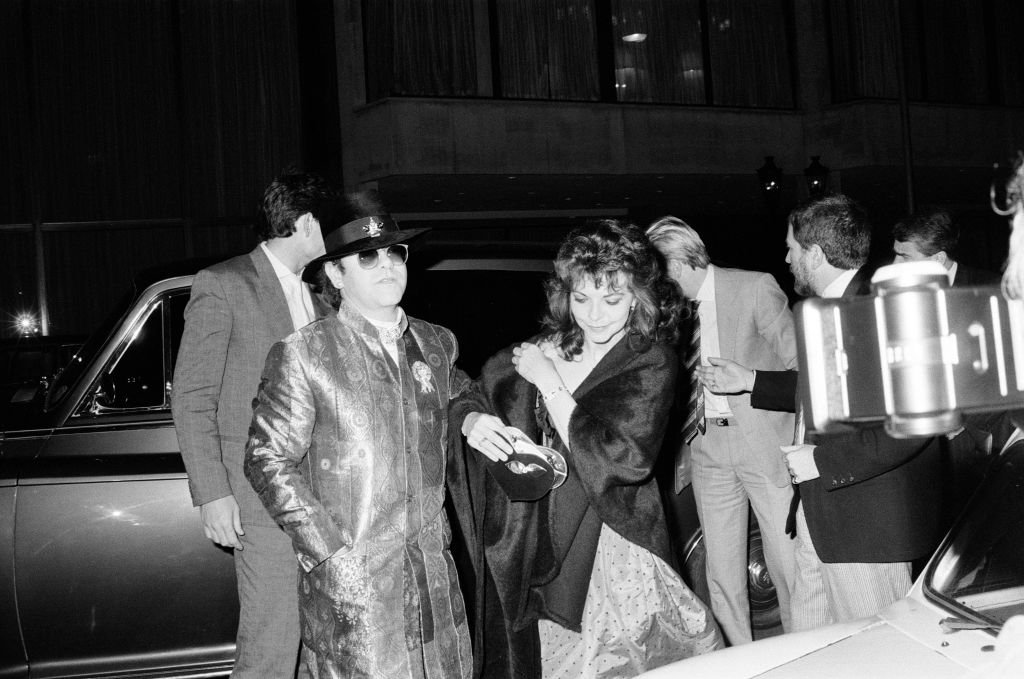 Image Credit: Getty Images / English singer and pianist Elton John with his wife Renate Blauel at the theatre, London, UK, 17th February 1985.